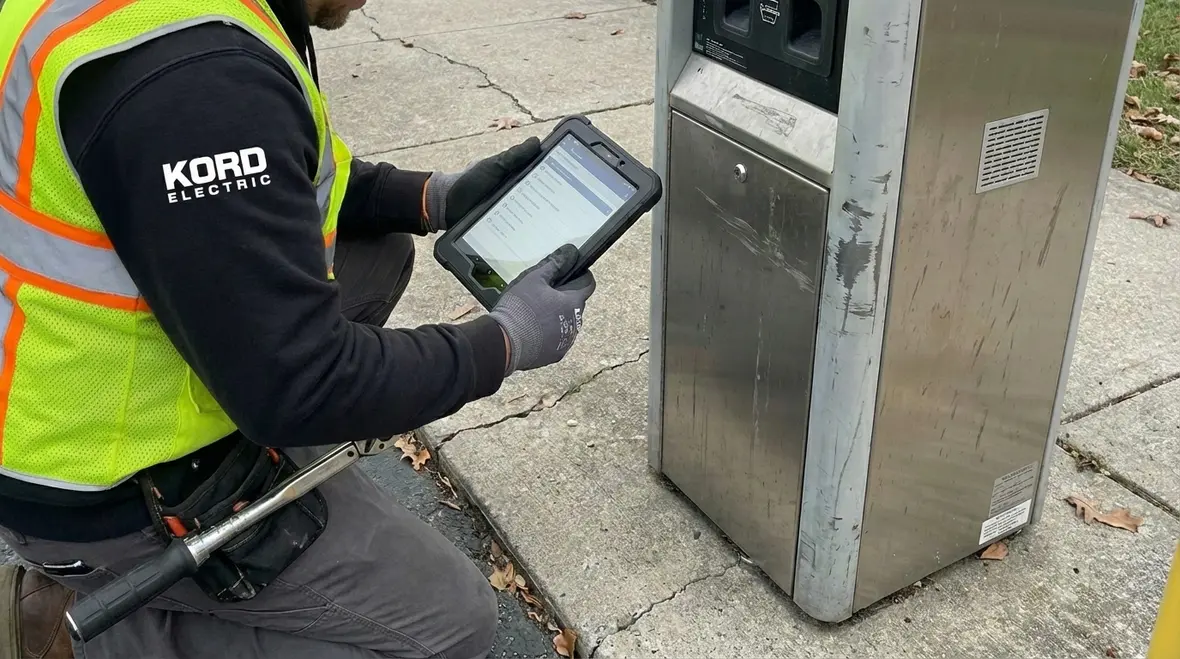 Technician performing EV charger maintenance at a commercial property