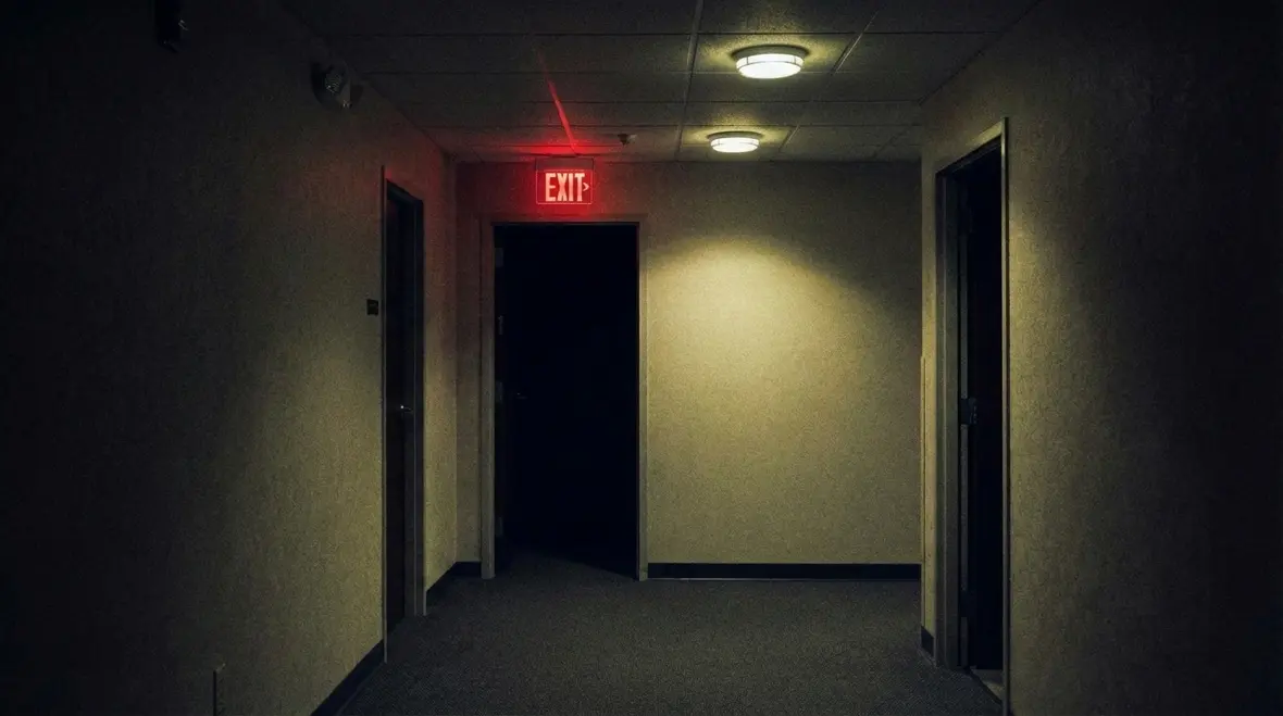 Technician inspecting emergency exit lighting in a commercial facility