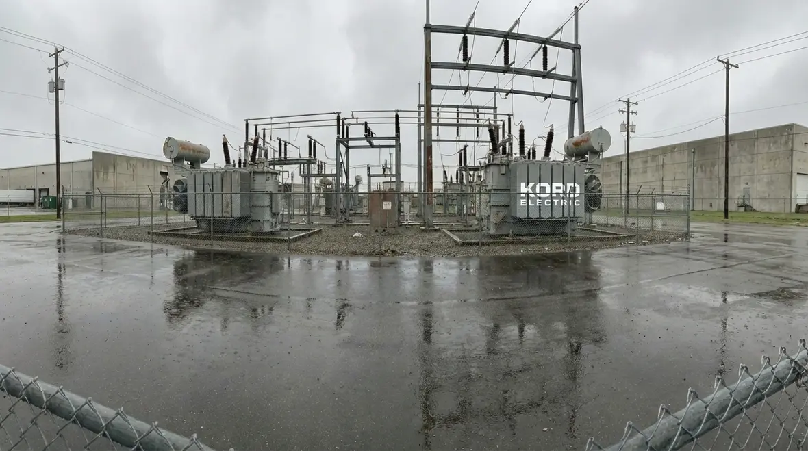 Technician performing storm damage electrical inspection in a commercial facility
