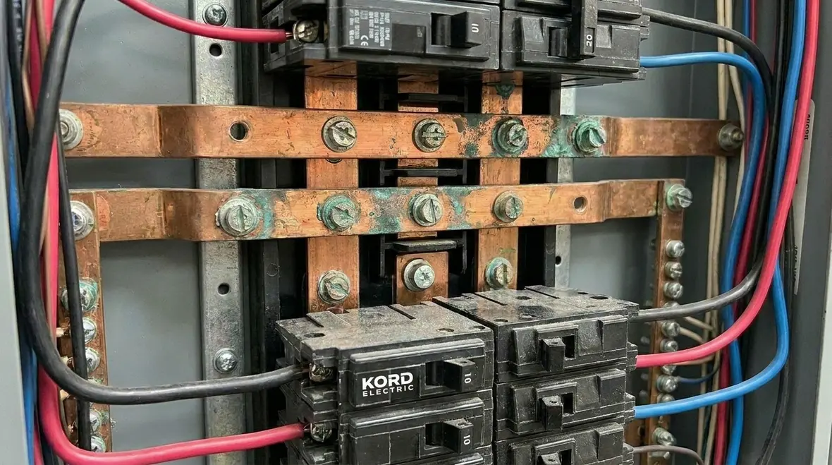 Technician reviewing commercial panel warning signs
