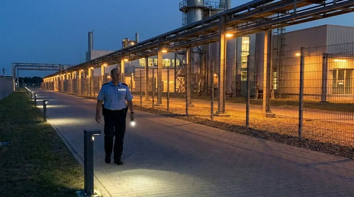 Technicians configuring automated exterior lighting controls for a facility