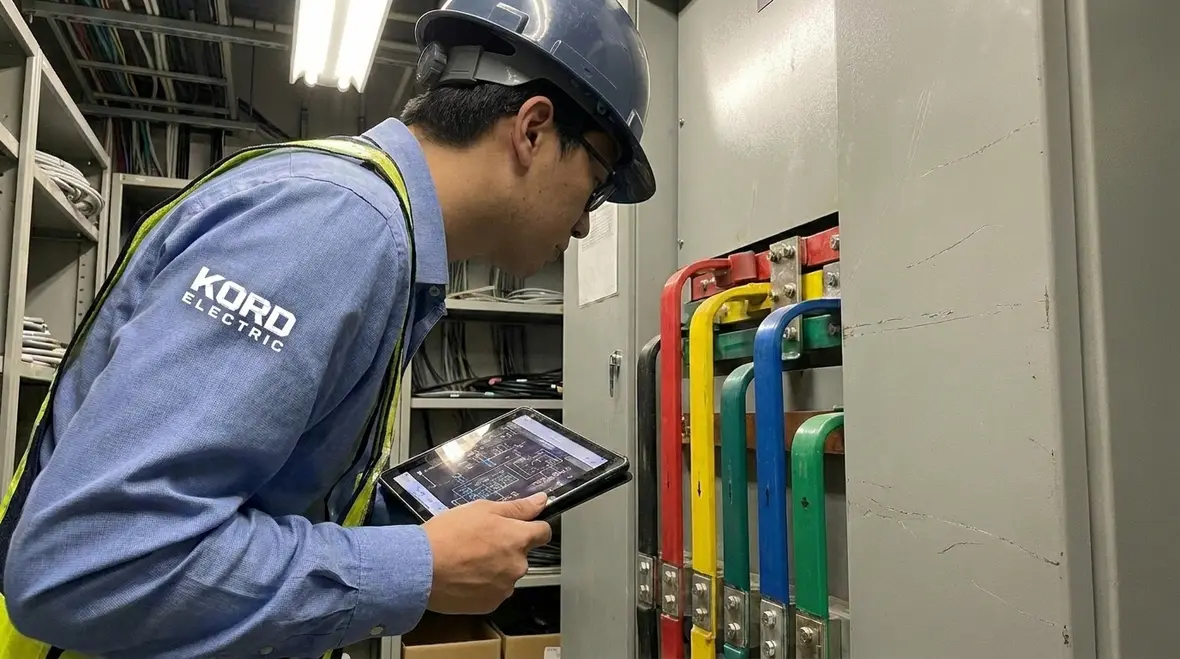 Technicians reviewing data center power distribution for uptime and reliability