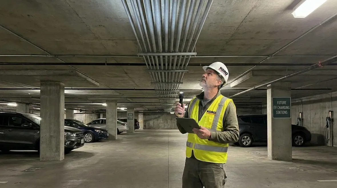 Technicians reviewing electrical plans for commercial EV charger installation