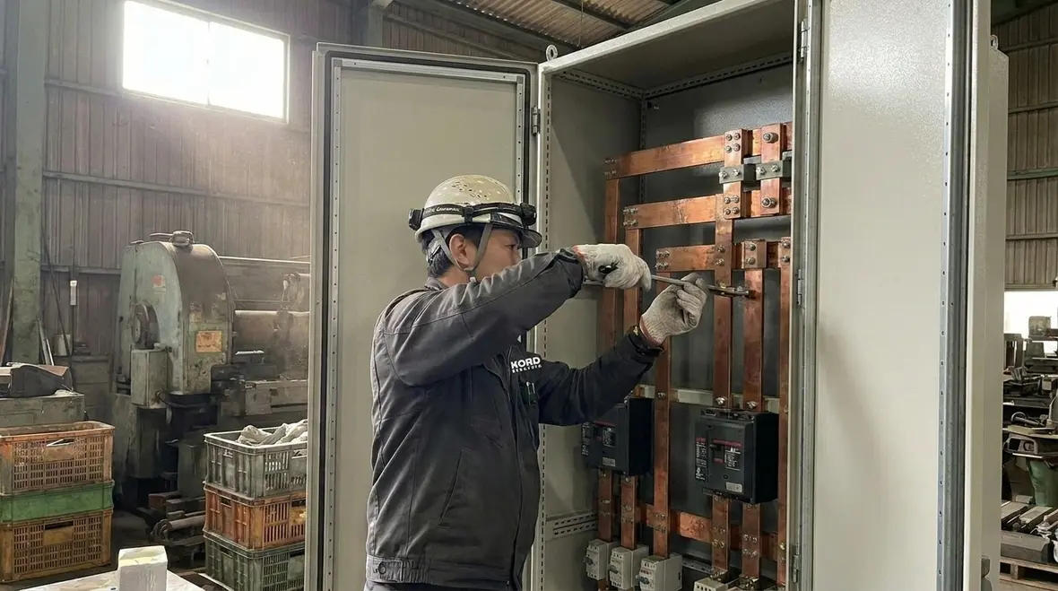 Technicians reviewing electrical upgrades for a manufacturing plant