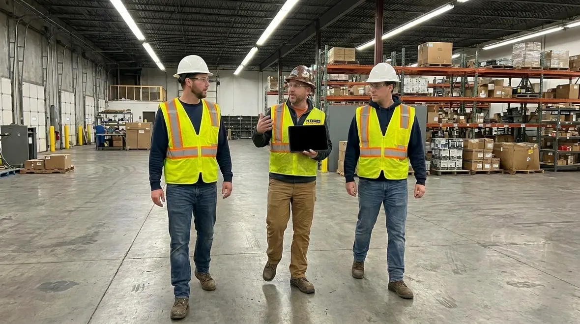 Technicians planning phased electrical infrastructure upgrades in a commercial facility