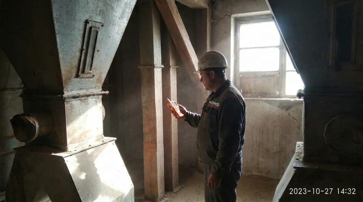 Technician reviewing NEC hazardous location boundaries in a commercial facility