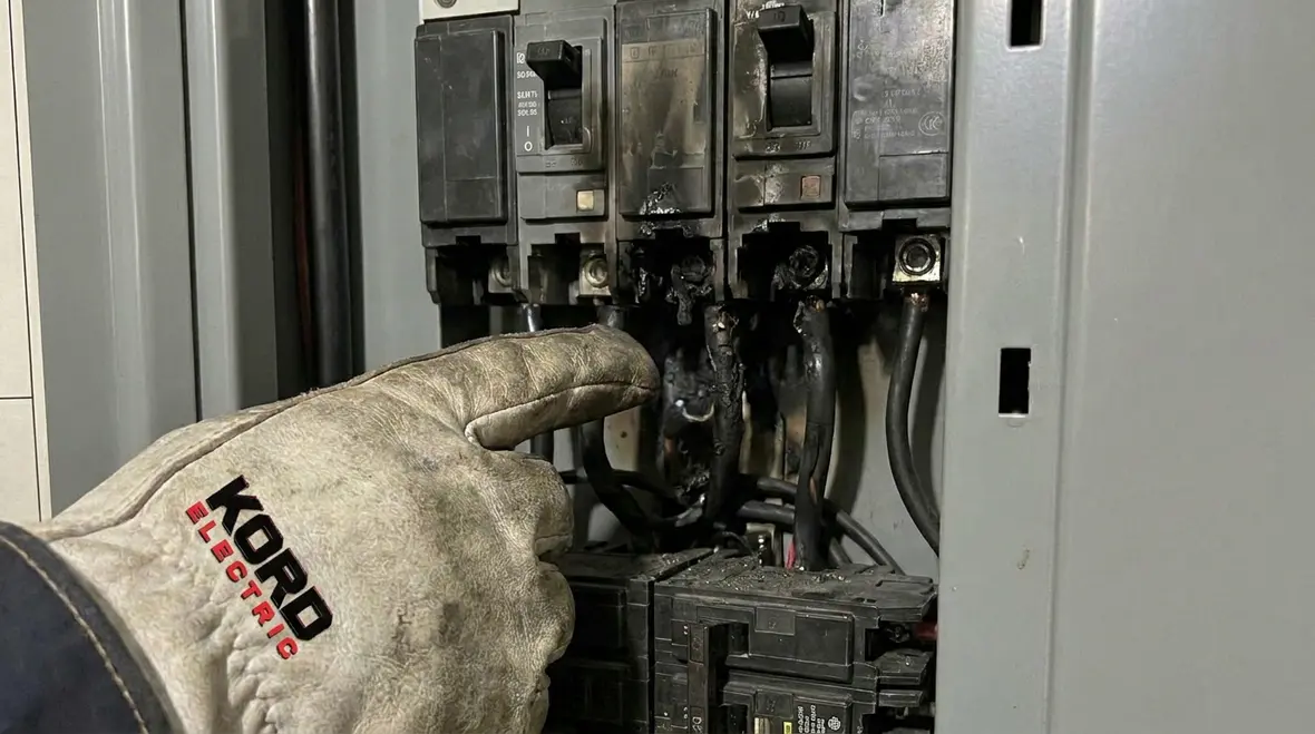 Commercial electrical panel with visible signs of overheating and aging components