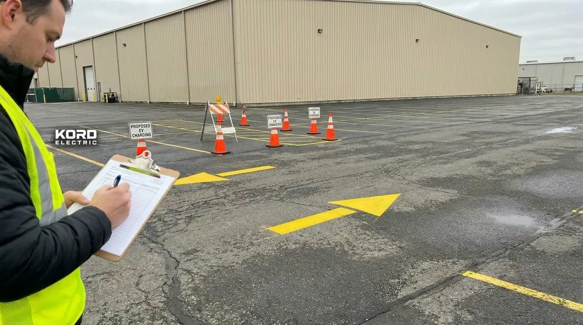 Manager reviewing EV charger layout on a commercial site plan