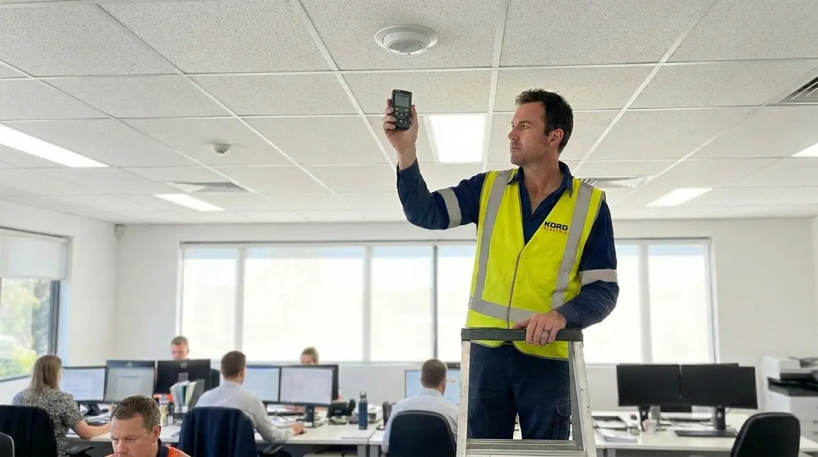 Electricians commissioning commercial lighting control system