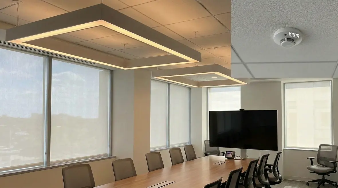 Technician tuning commercial lighting control zones for energy savings