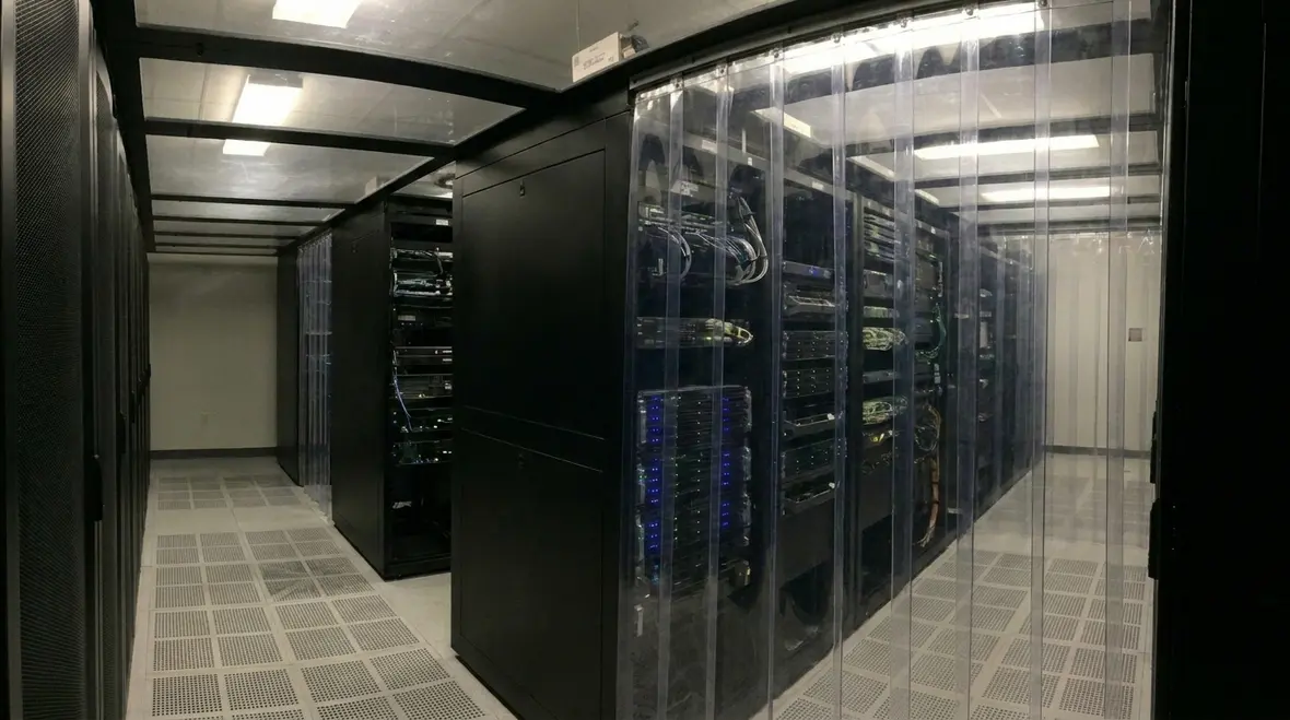 Technicians reviewing cooling and electrical performance in a data center
