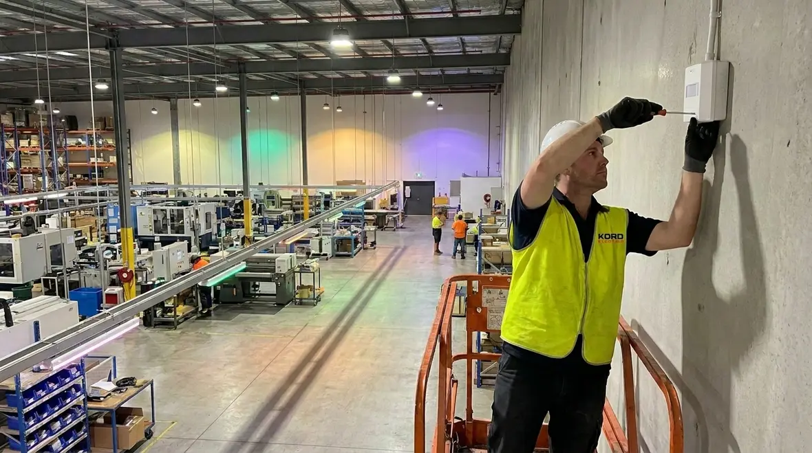 Maintenance team reviewing reduced lighting work orders after LED retrofit