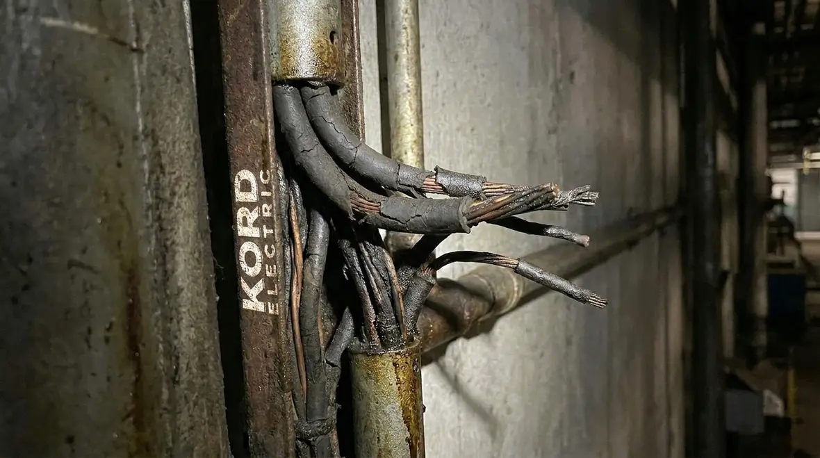 Close-up of industrial wiring repair and troubleshooting work in progress