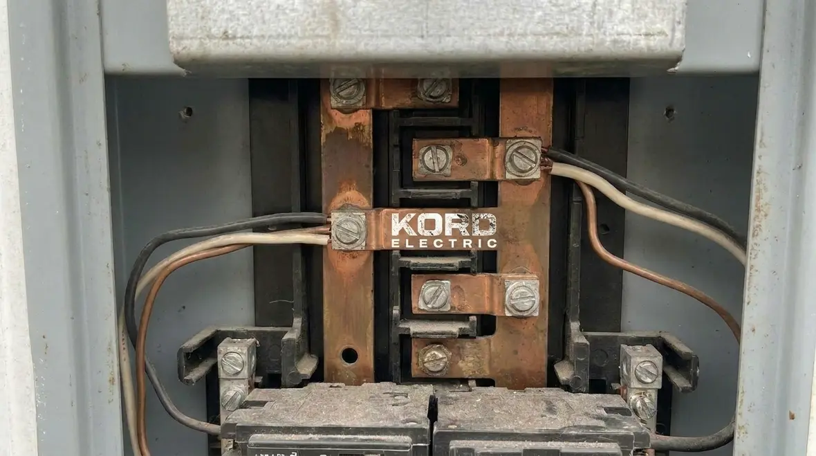 Electrician diagnosing intermittent circuit breaker trips in an office panel