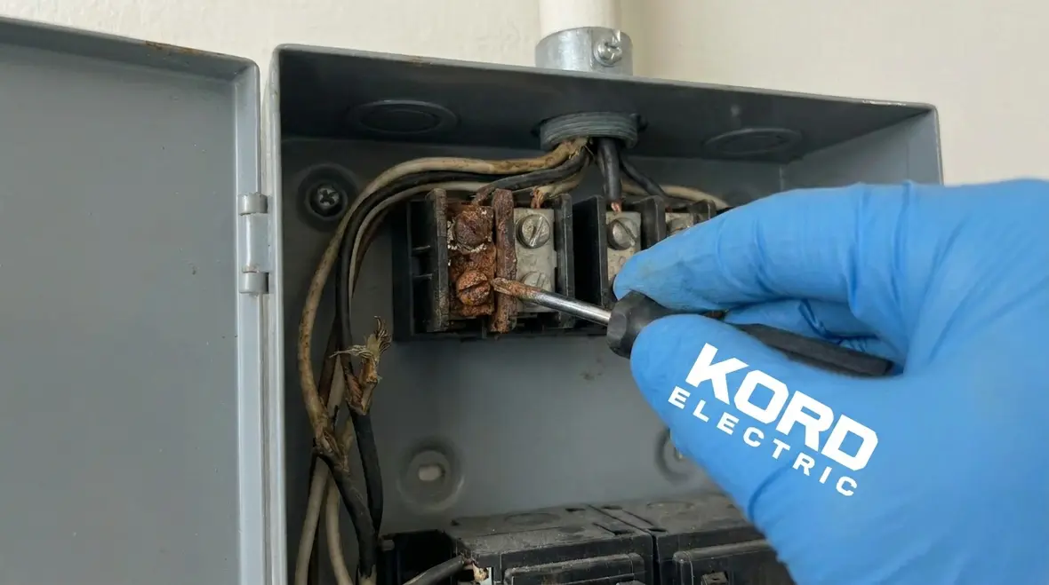 Technicians using diagnostic tools to troubleshoot intermittent electrical faults in a commercial facility