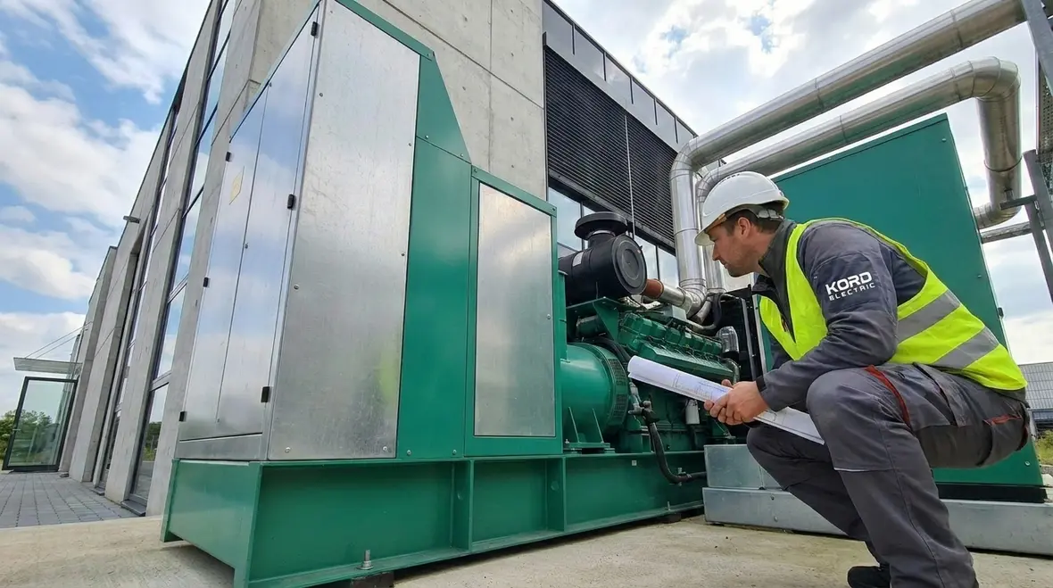 Technicians reviewing Business Continuity Power Planning diagrams for a commercial facility