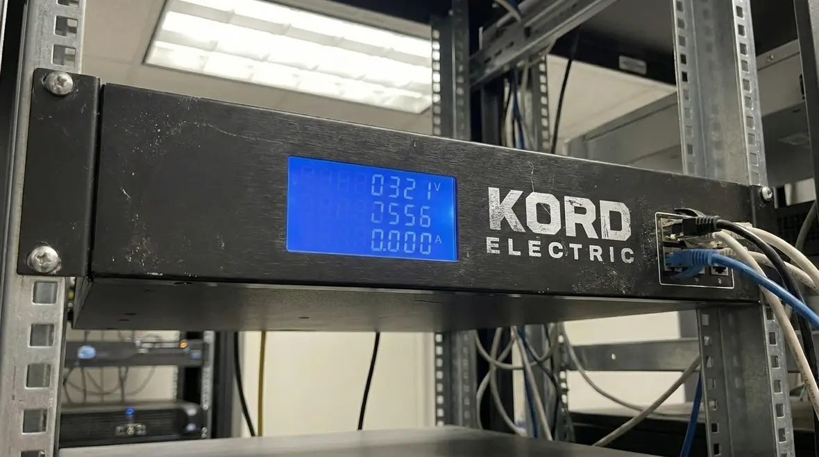 Technicians reviewing data center power quality monitoring dashboard
