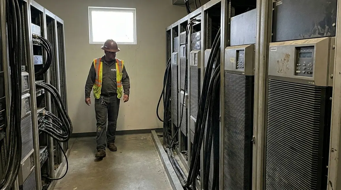 Technicians reviewing commercial UPS loads during system sizing