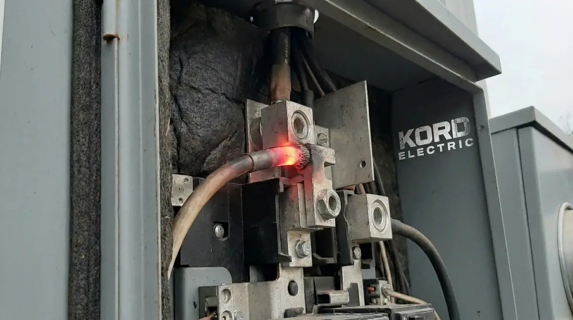 Technician using thermal imaging on a commercial electrical panel