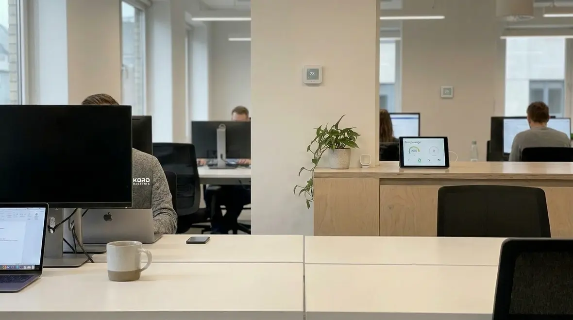 Technician reviewing smart building energy management controls in a modern office
