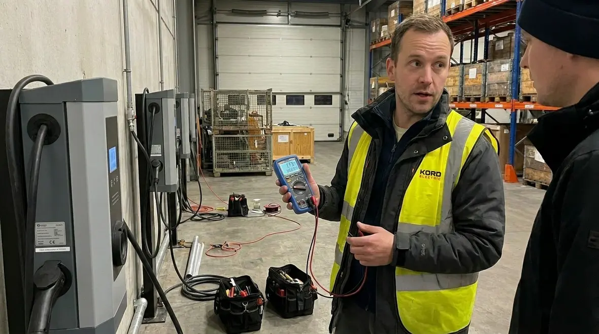 Technicians reviewing commercial building electrical panels before EV upgrade