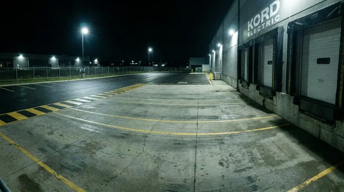 Well-lit commercial parking lot and pathways at night