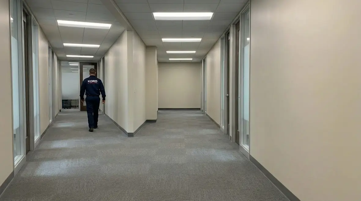 Technicians reviewing commercial smart lighting savings on a facility energy dashboard