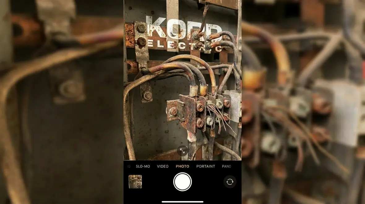 Technician inspecting an aging commercial electrical panel for troubleshooting