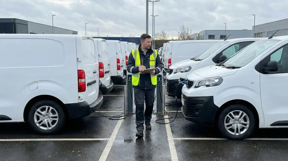 Technicians assessing commercial EV fleet parking and charging needs