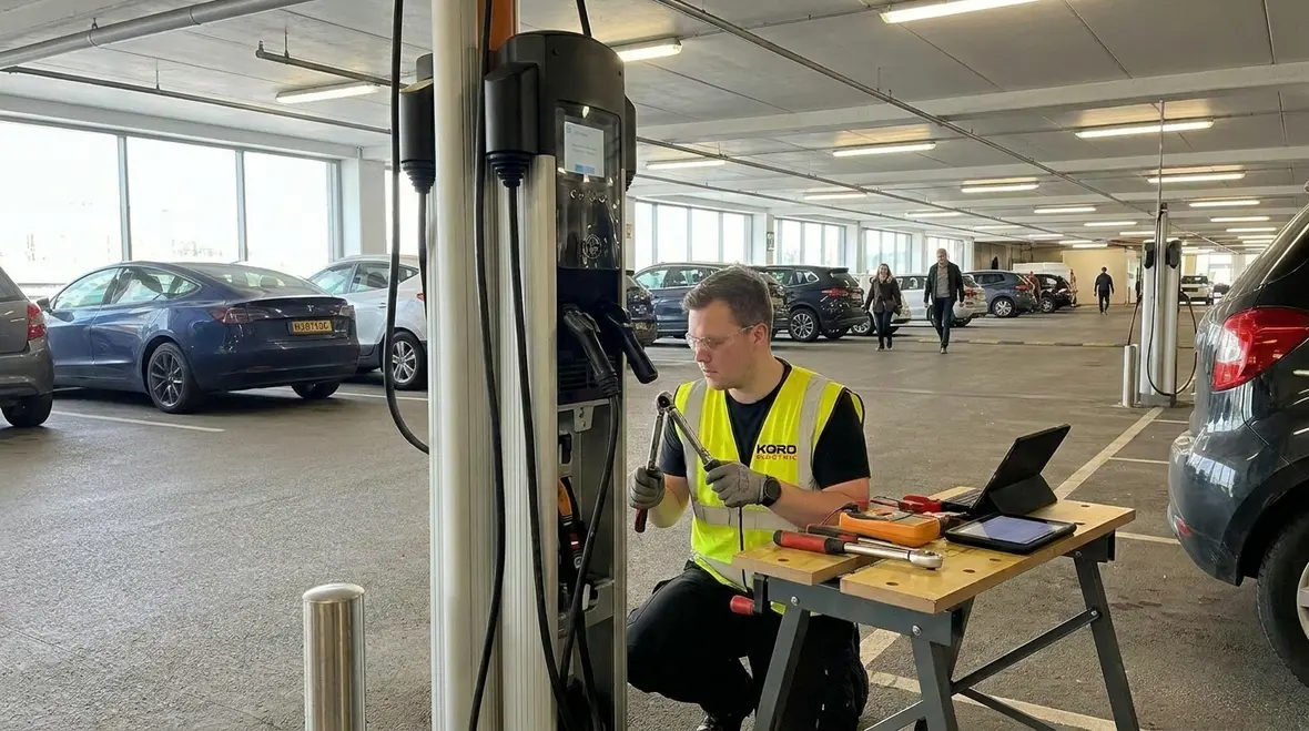 Technicians performing preventive maintenance on commercial EV chargers