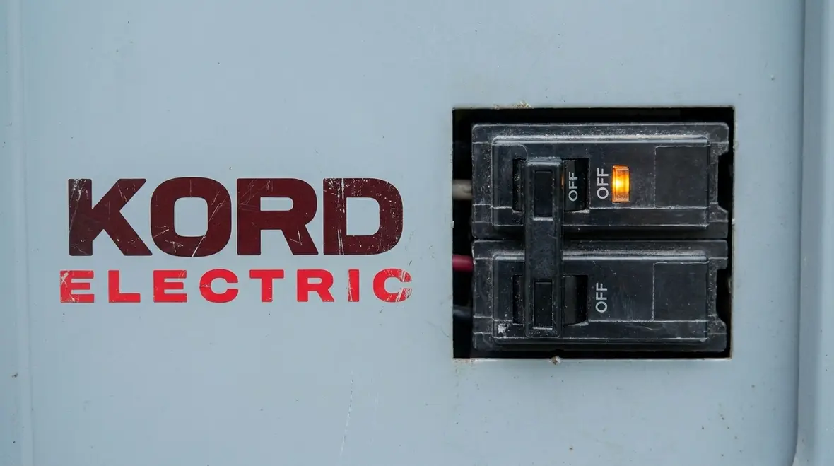 Commercial electricians reviewing escalation steps for office electrical issues