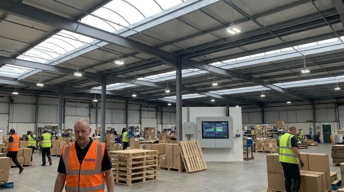 Technician reviewing commercial lighting fixtures for California energy code compliance