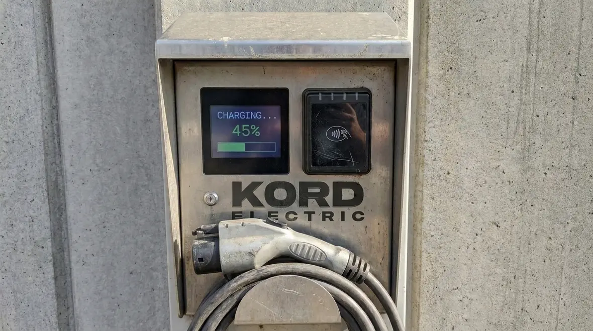 Technicians reviewing commercial EV charging design and load profile