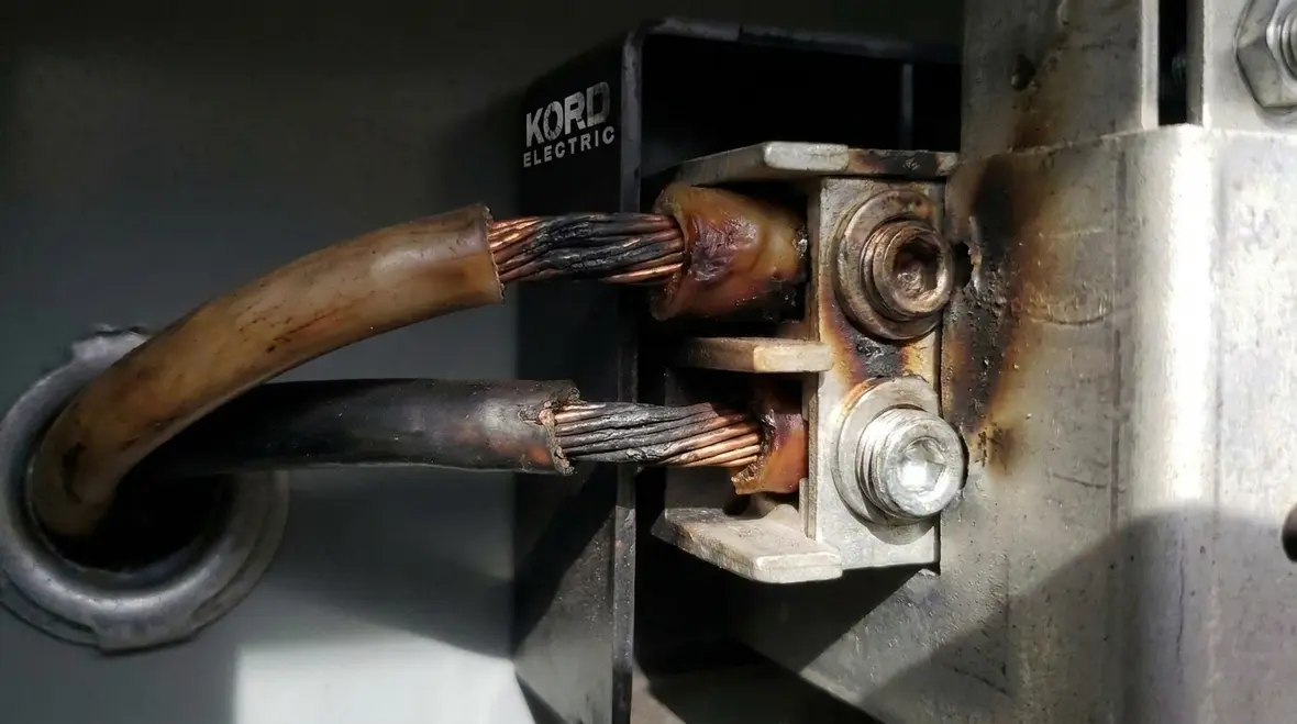 Technician performing fire prevention checks on a commercial electrical panel