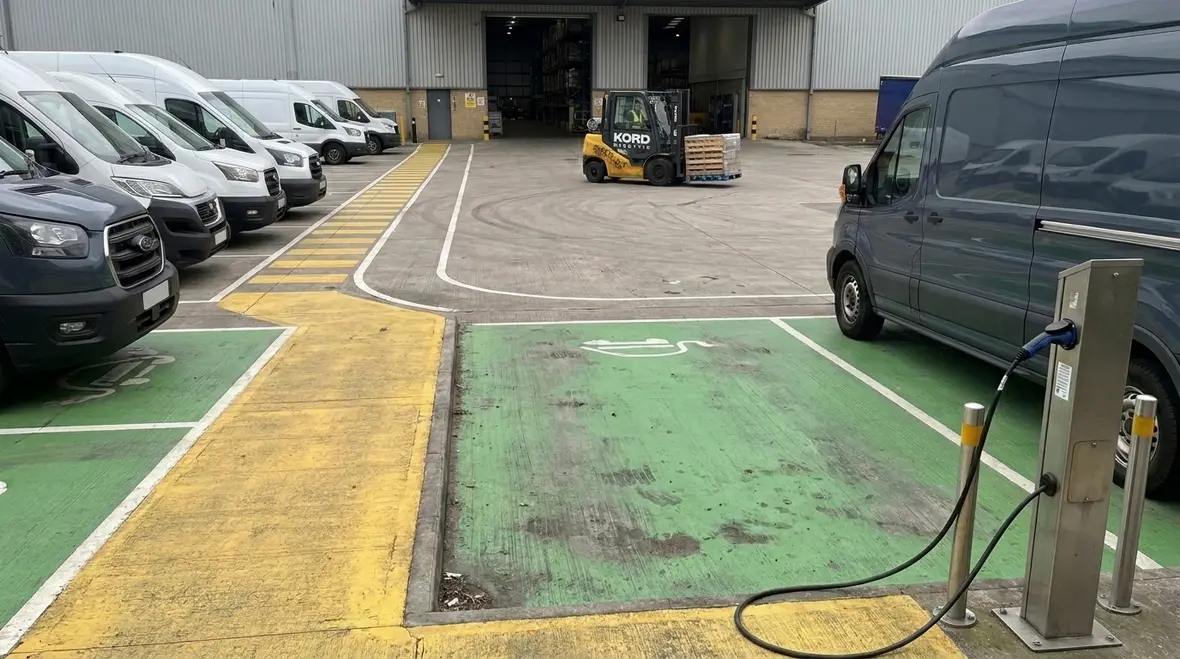 EV fleet charging layout with clear safety markings and vehicle flow lanes