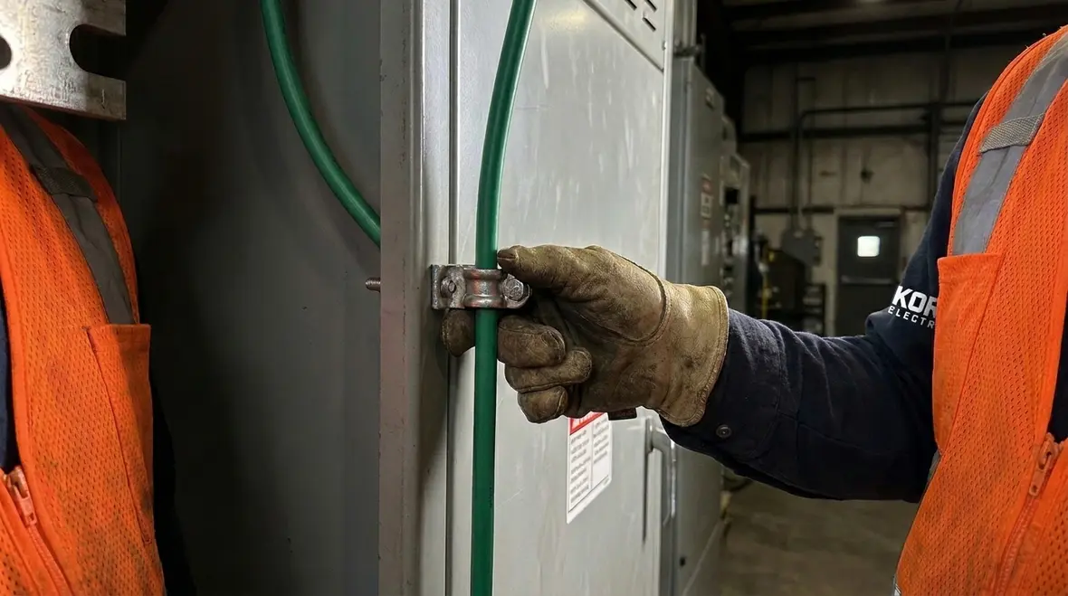 Technicians reviewing NEC grounding and bonding over 2 kV design