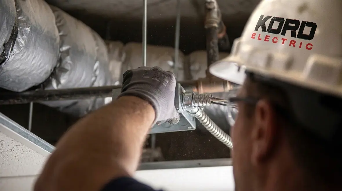 Close-up of compliant NEC FMC plenum duct wiring with access openings