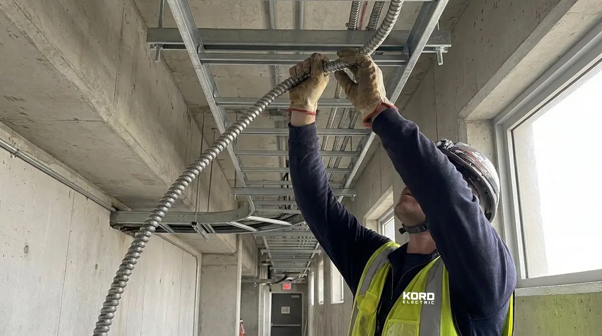 Inspector reviewing NEC MC cable construction issues during an electrical inspection