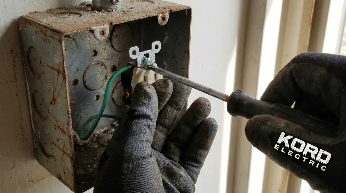 Closeup of NEC NM cable grounding conductor terminations inside a junction box