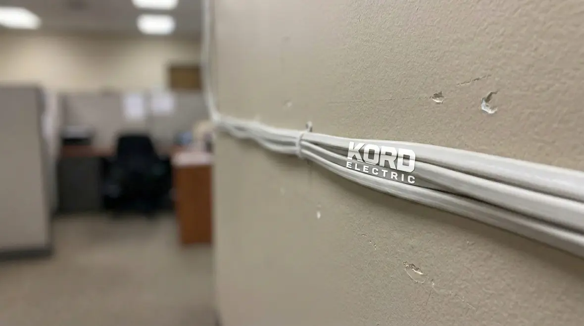 Interior NM cable installation in permitted low-risk commercial space