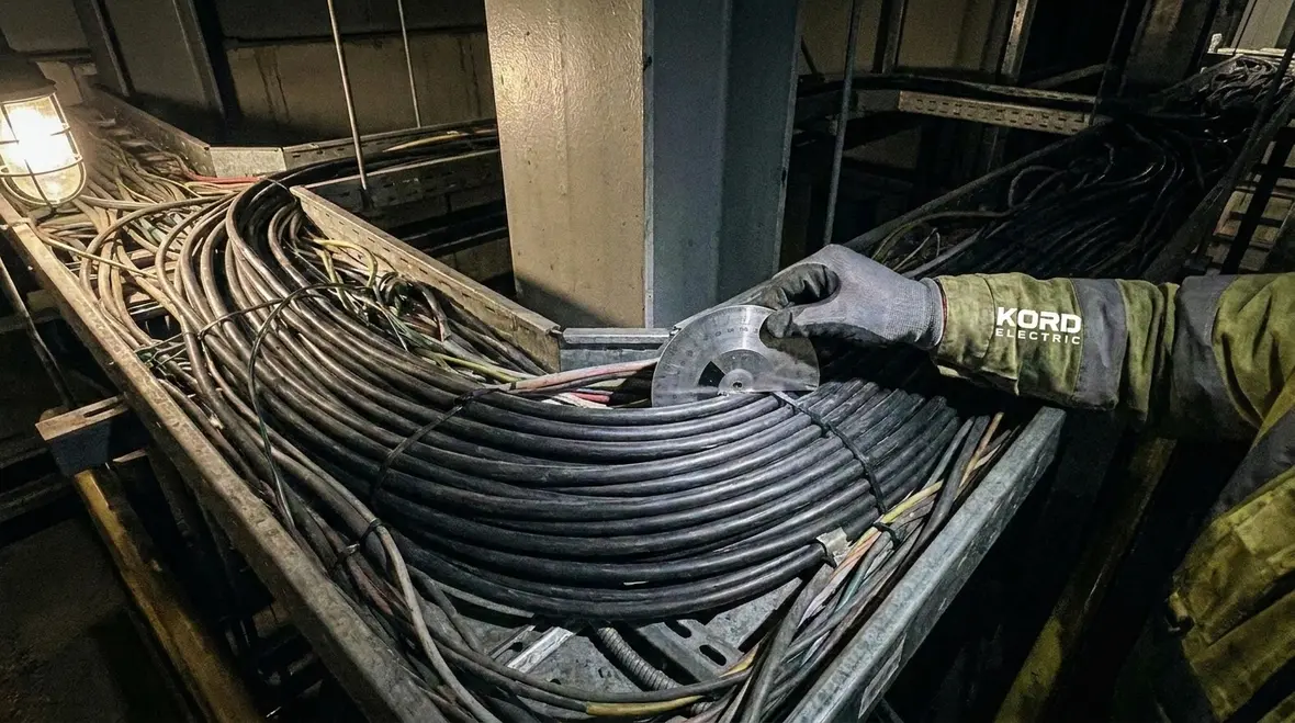 Technician inspecting NEC SEC cable insulation rating in an industrial facility