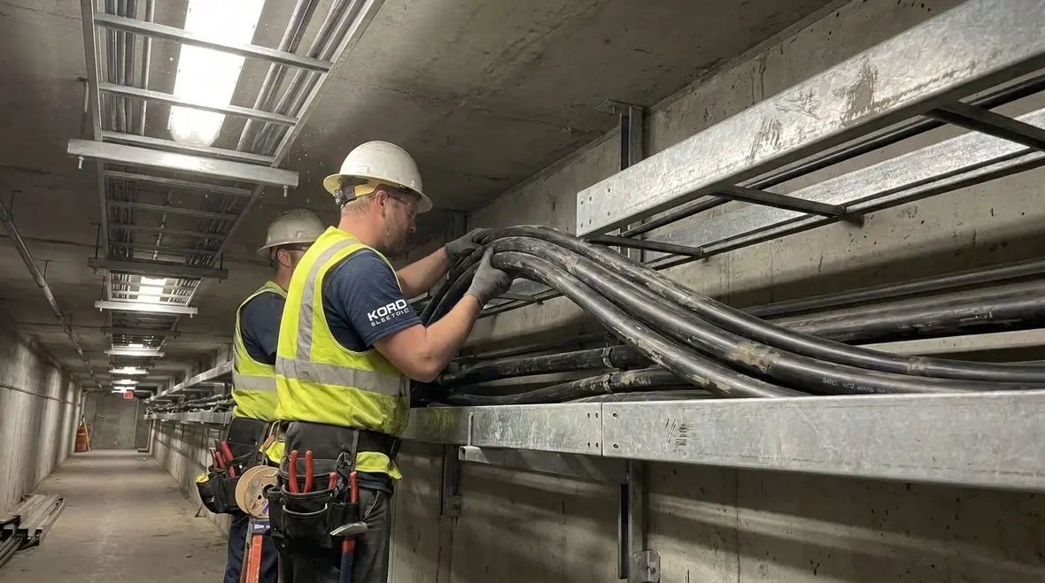 Technician inspecting NEC SEC cable conductors for NFPA 70 Section 332.104 compliance