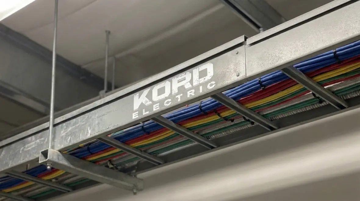 Technician planning NEC Section 640.24 audio wireway gutter wiring in a commercial facility