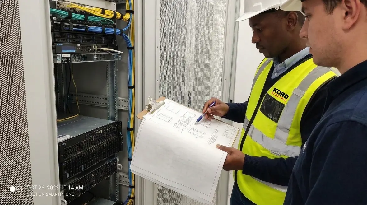 Engineer reviewing IT room lighting and electrical plans