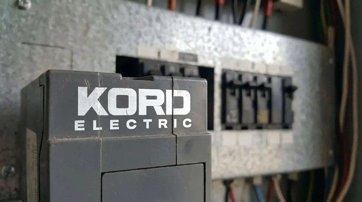 Engineer verifying available fault current labels during commercial electrical inspection