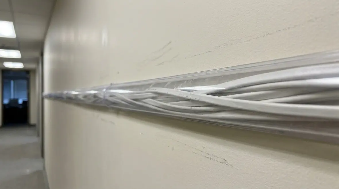 Code-compliant exposed NM cable routing in a commercial ceiling space