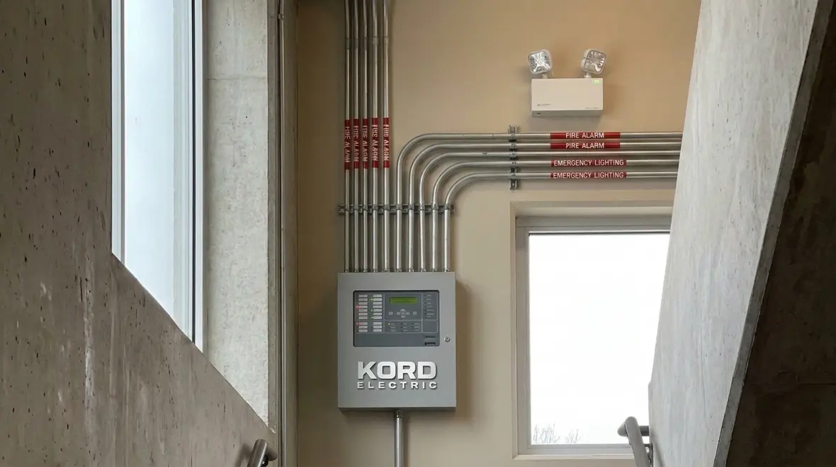 Kord Electric technicians reviewing stair tower wiring routes
