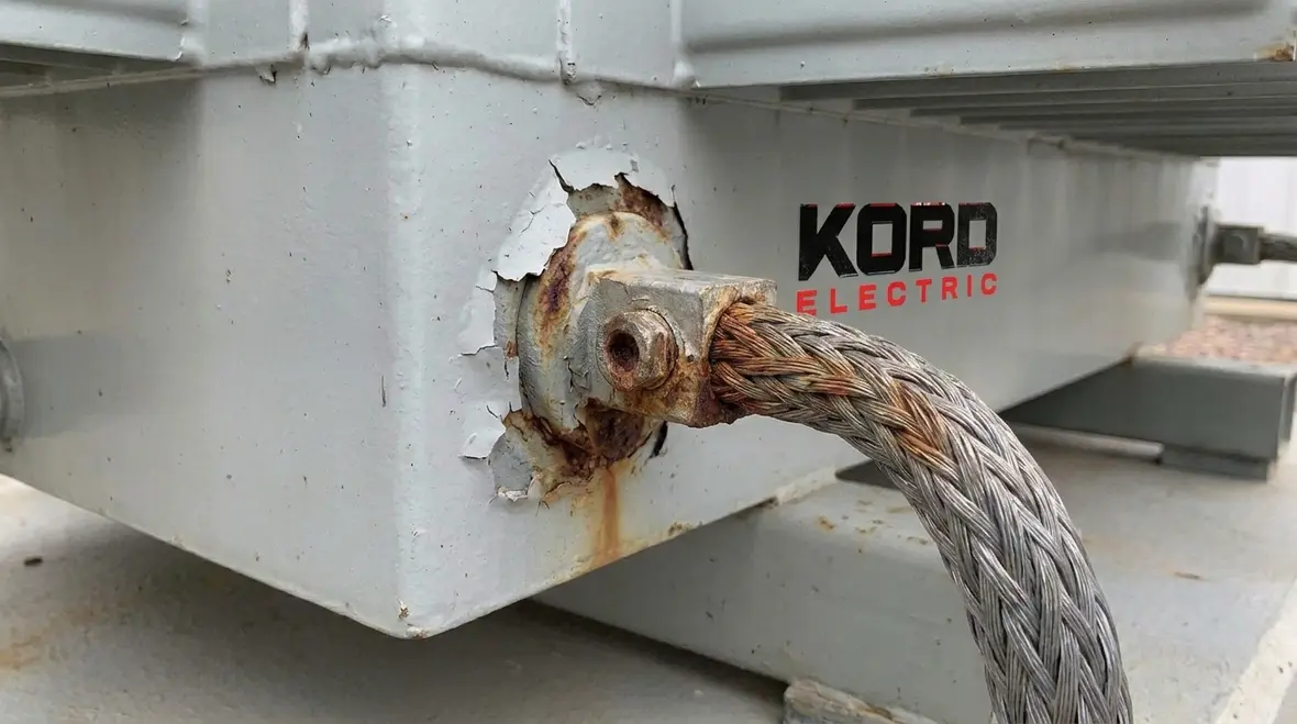 Technician verifying bonding and grounding continuity on instrument transformer cases