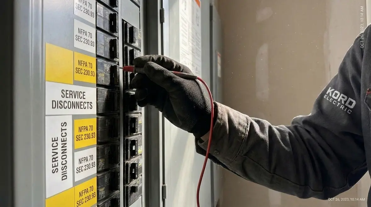 Electrician reviewing NEC protection of specific circuits at the service