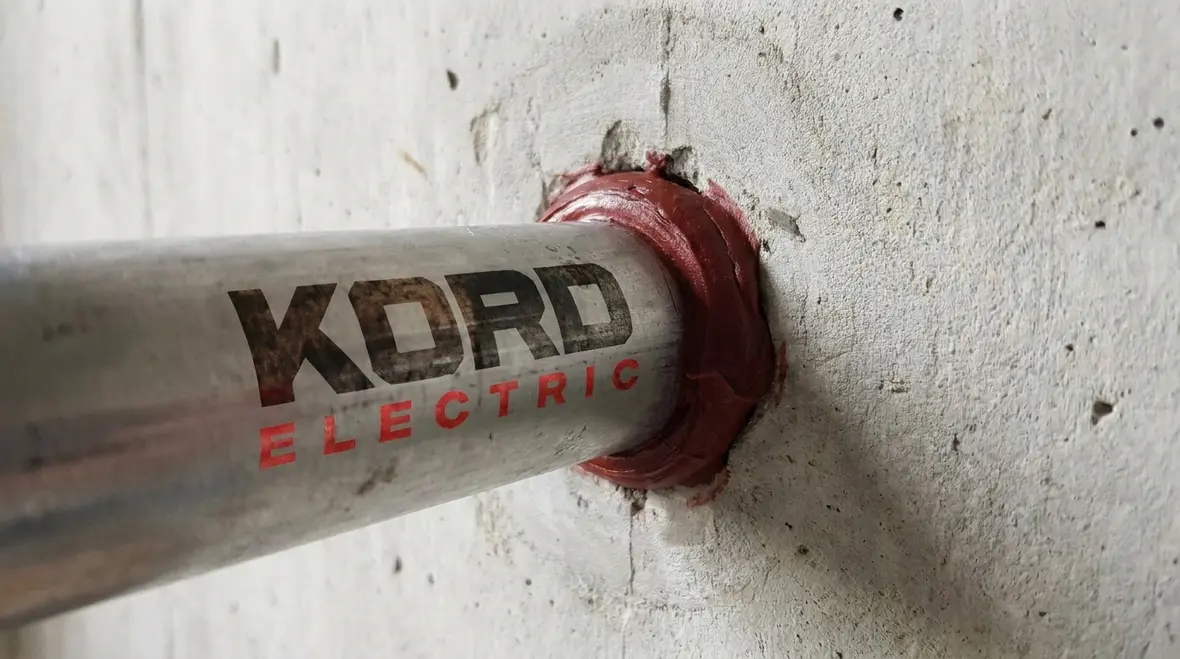 Conduit raceways passing through a commercial floor slab with proper sealing locations marked